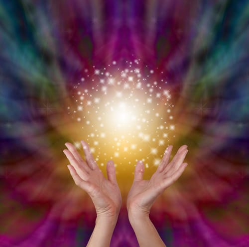 Image of hands in the air holding up a ball of light with a tie dye background