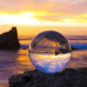 Image of a glass sphere on a rock near a body of water used to illustrate Energetic Healing page