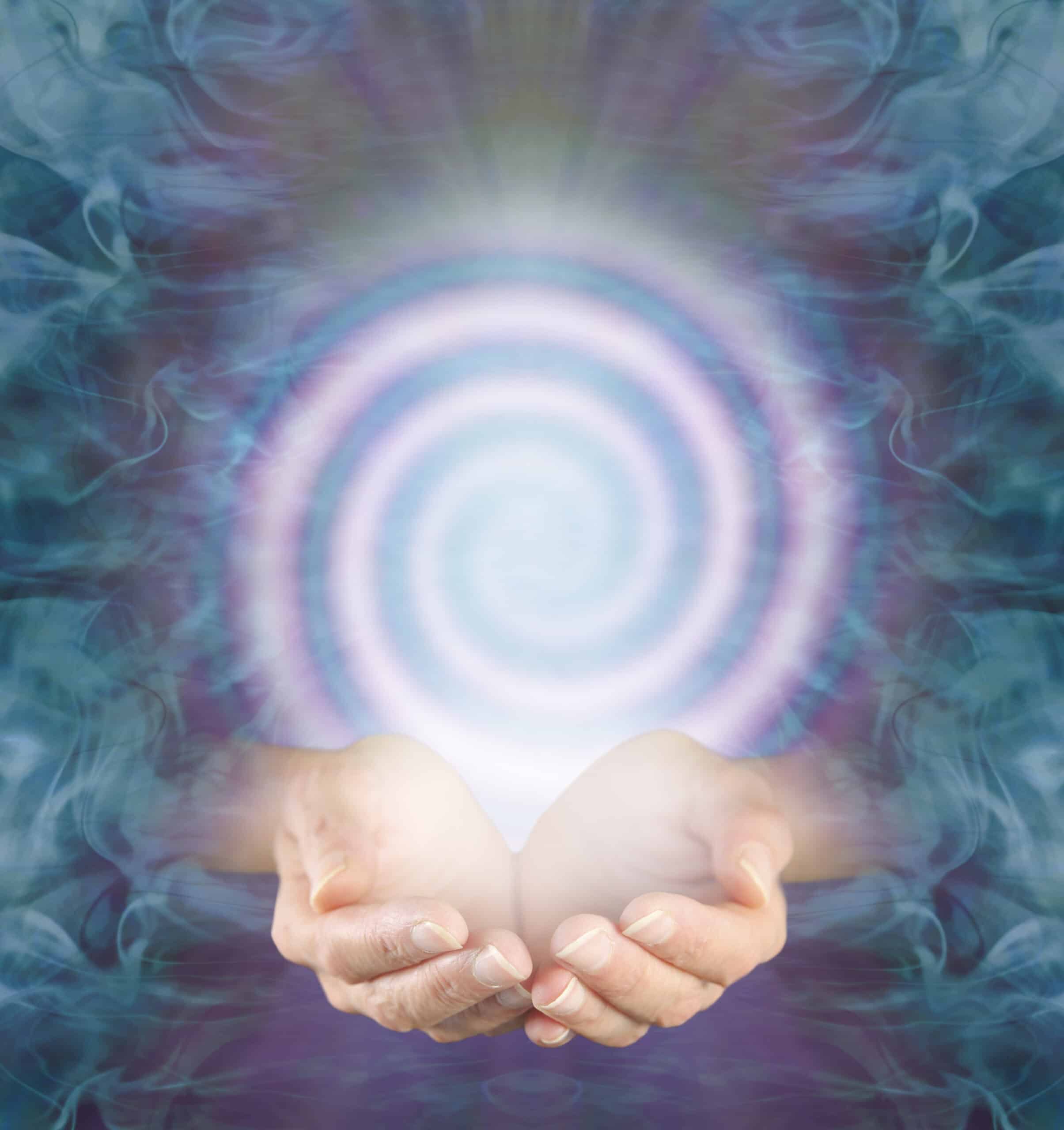 female cupped hands with a pink spiral above against an intricate jade green purple energy background and copy space