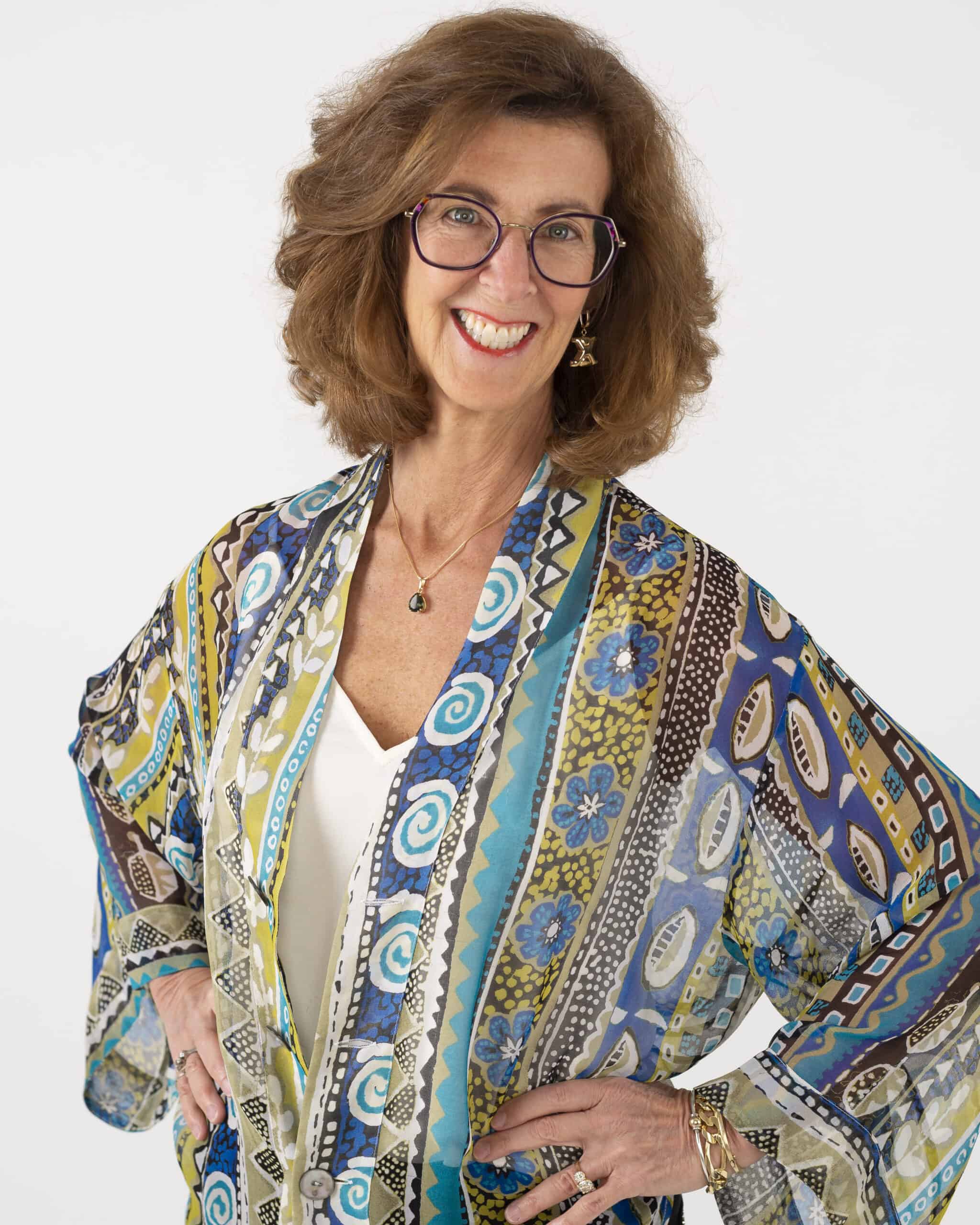 Image of Nancy Clairmont Carr in a white v-neck blouse and colorful cardigan